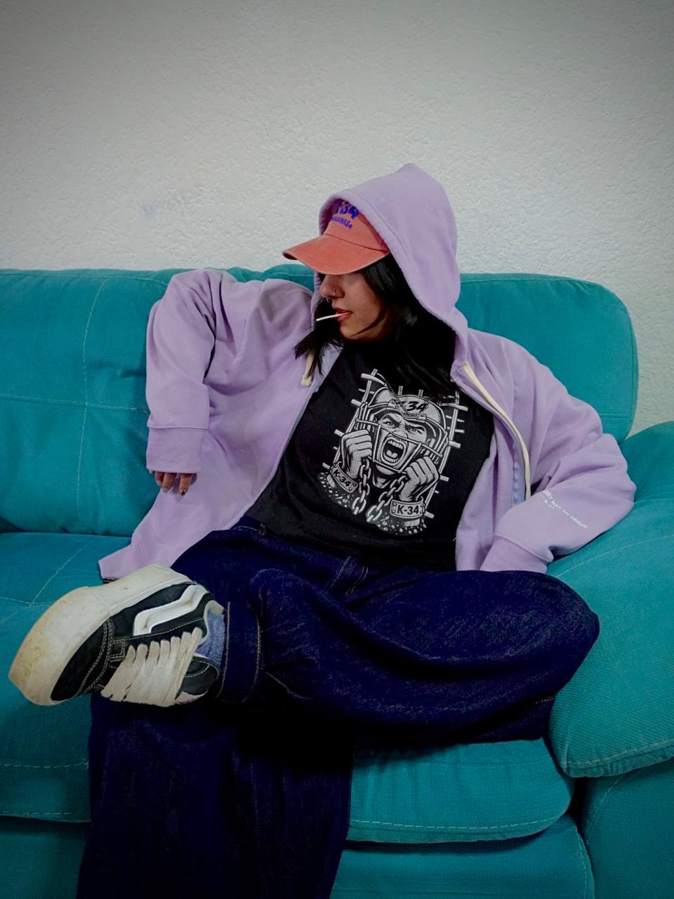 Hoodie lila con cierre, playera casco negra y gorra coral